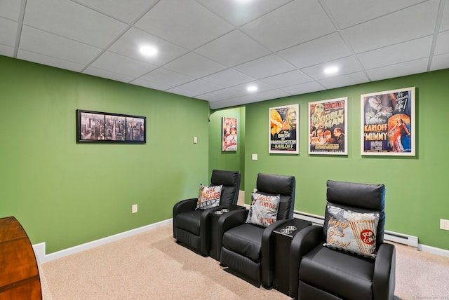 home theater with carpet floors, a baseboard radiator, and a paneled ceiling