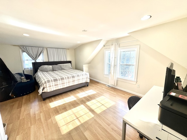 bedroom featuring vaulted ceiling and light wood-type flooring