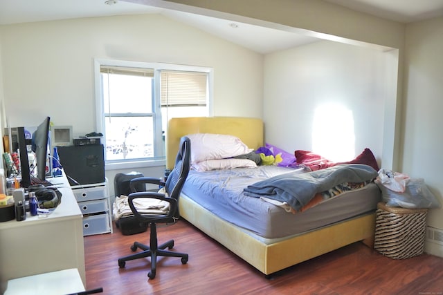 bedroom featuring dark hardwood / wood-style floors and vaulted ceiling