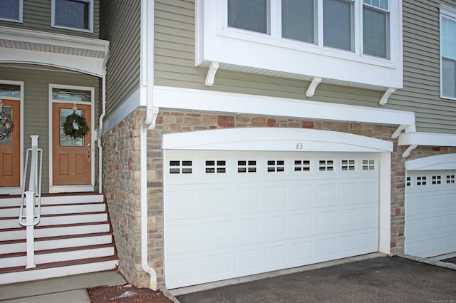 doorway to property featuring a garage