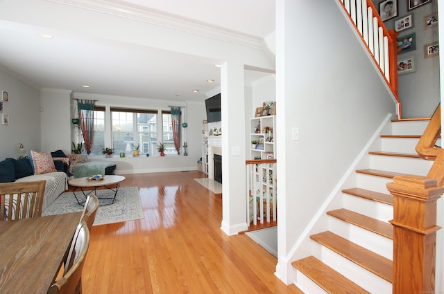 stairway featuring crown molding and wood-type flooring