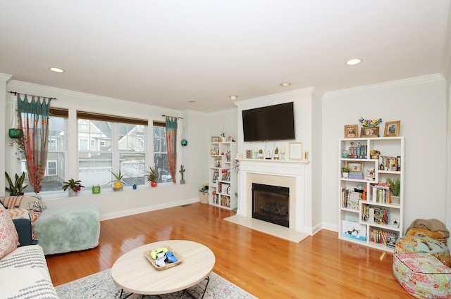 living room featuring hardwood / wood-style flooring and ornamental molding