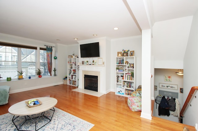 living room with crown molding and hardwood / wood-style flooring