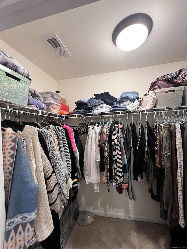 walk in closet with carpet