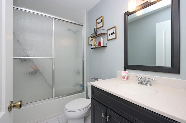 full bathroom featuring vanity, enclosed tub / shower combo, and toilet