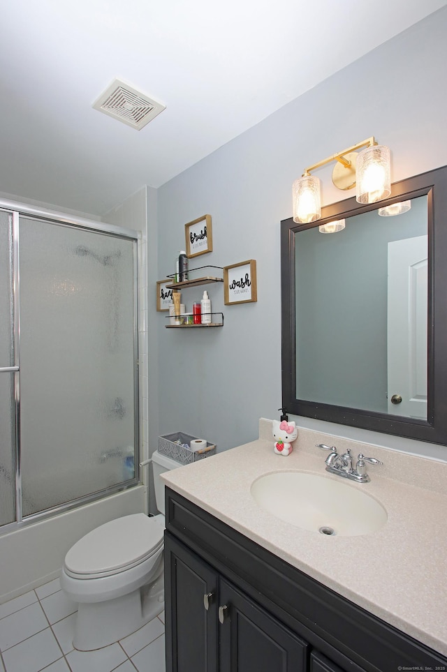 full bathroom featuring vanity, tile patterned floors, enclosed tub / shower combo, and toilet