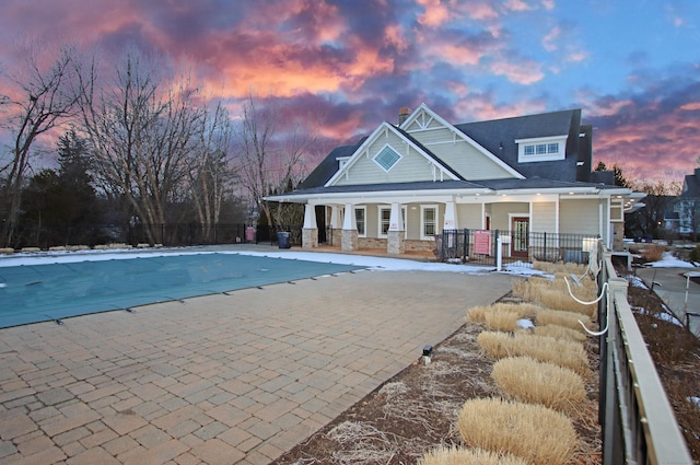 view of pool at dusk