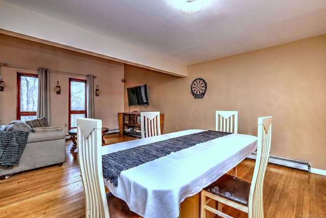 dining area featuring baseboard heating and hardwood / wood-style floors