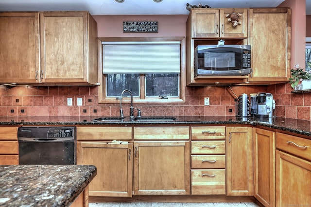 kitchen featuring sink, black dishwasher, a wealth of natural light, dark stone counters, and decorative backsplash