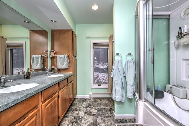 bathroom with a baseboard radiator, combined bath / shower with glass door, and vanity