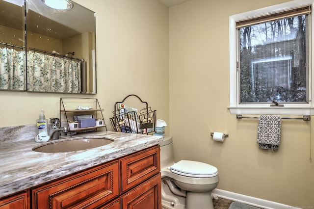 bathroom with vanity, walk in shower, and toilet