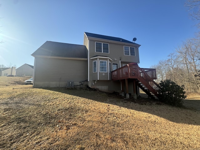 rear view of property featuring a deck and stairs