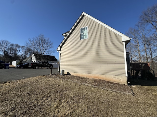 view of side of home with a wooden deck