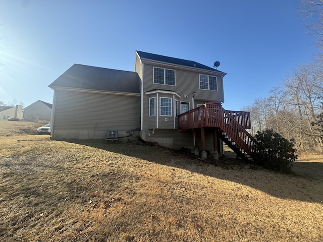 rear view of property with a wooden deck and stairs