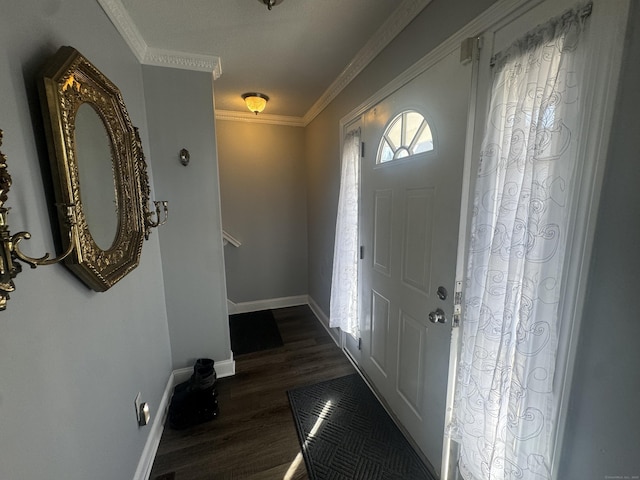 foyer entrance featuring dark wood-style floors, baseboards, and ornamental molding