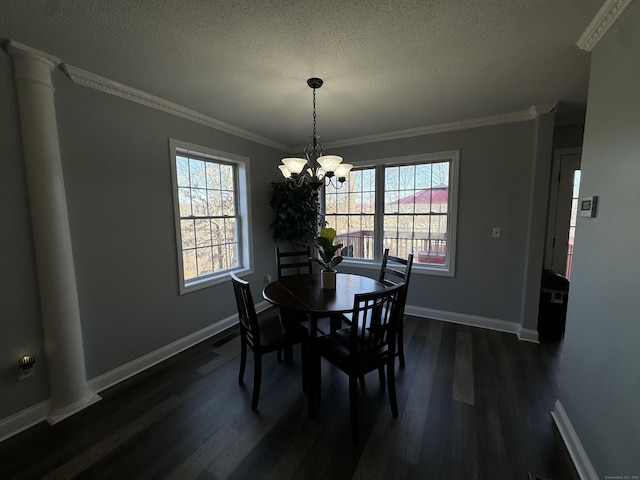 dining area with dark wood-type flooring, an inviting chandelier, crown molding, and a textured ceiling