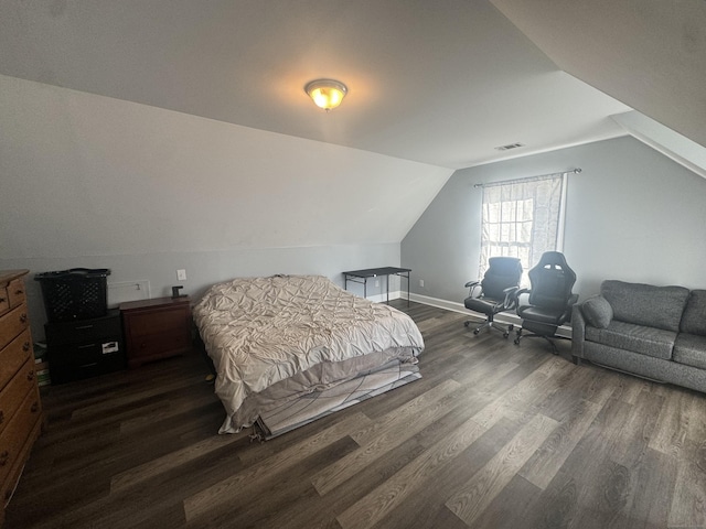 bedroom with vaulted ceiling, visible vents, baseboards, and dark wood-style flooring