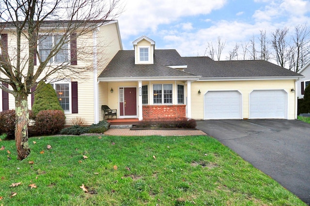 view of front of property featuring a garage and a front lawn