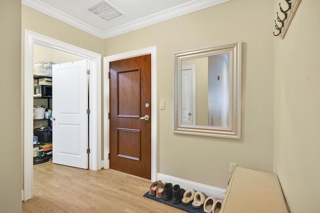 corridor with crown molding and light hardwood / wood-style flooring