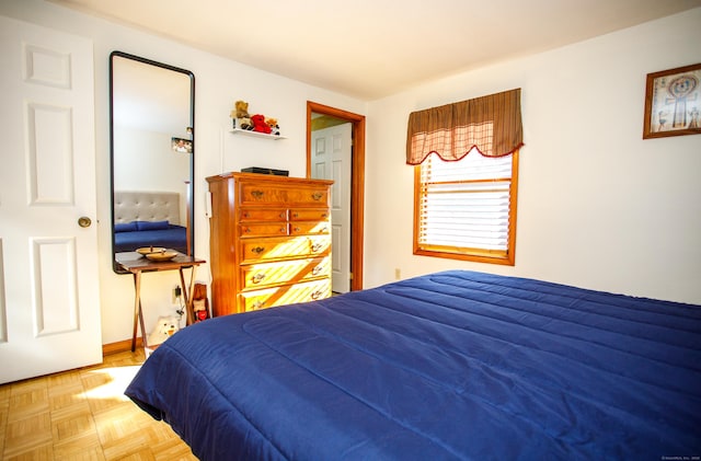 bedroom featuring parquet flooring