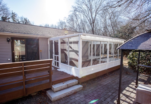 deck featuring a patio and a sunroom