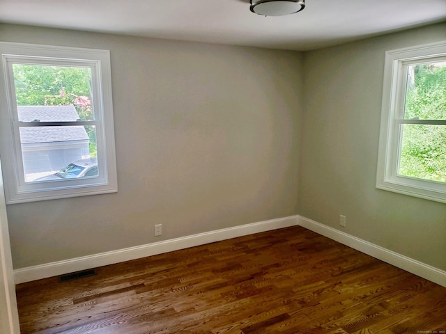 unfurnished room with dark hardwood / wood-style floors