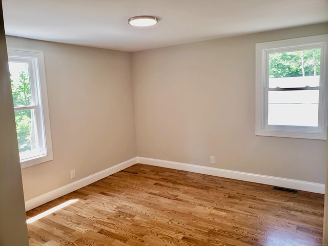 spare room featuring light hardwood / wood-style flooring