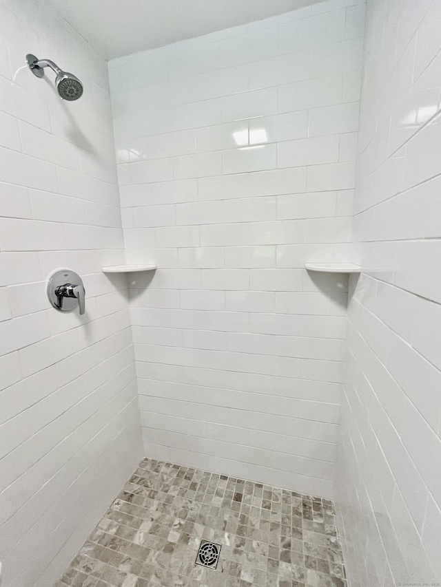 bathroom with tiled shower