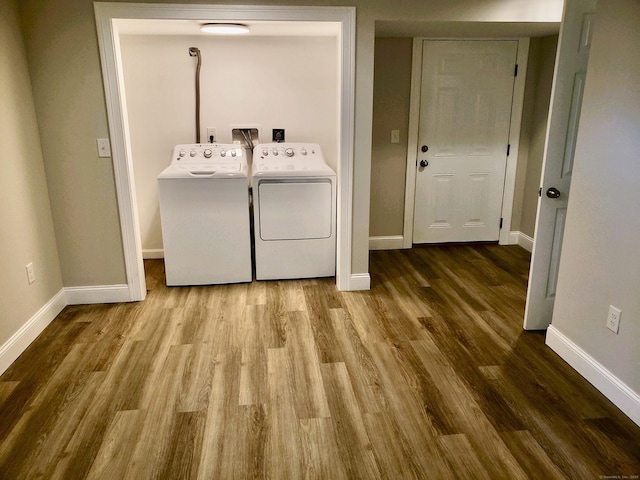 laundry area with wood-type flooring and separate washer and dryer