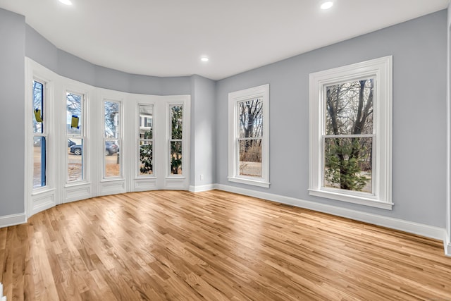 unfurnished room with light hardwood / wood-style floors