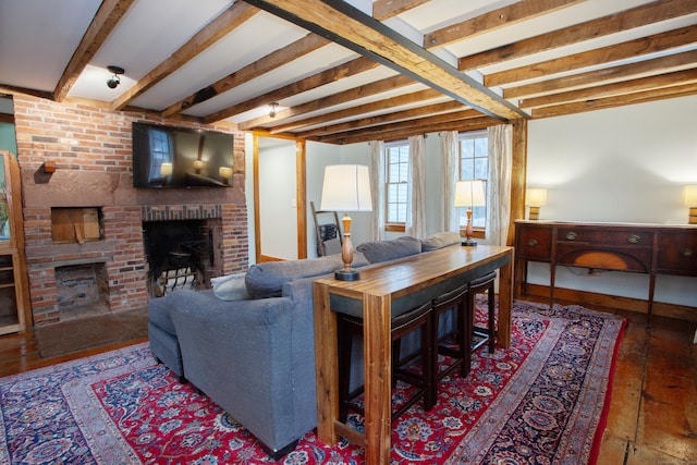 living room with dark hardwood / wood-style flooring, beam ceiling, and a brick fireplace