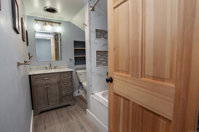 full bathroom with vanity, wood-type flooring,  shower combination, and toilet