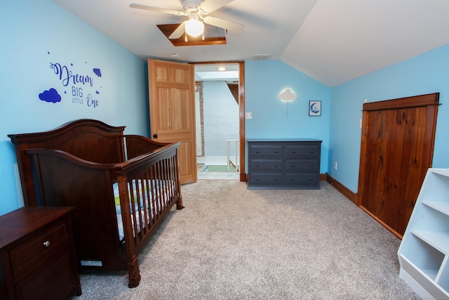 carpeted bedroom featuring vaulted ceiling and ceiling fan