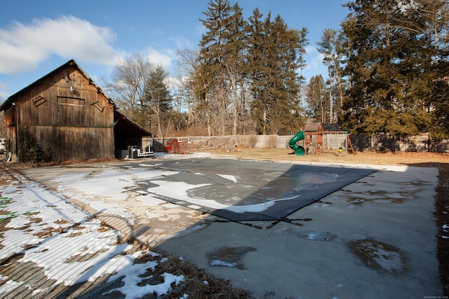 view of swimming pool with a playground