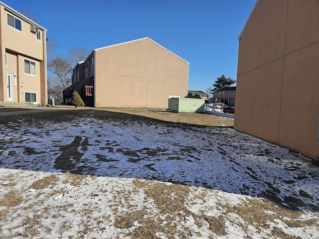 snowy yard featuring a residential view