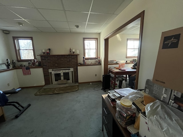 interior space featuring a paneled ceiling, plenty of natural light, and a fireplace