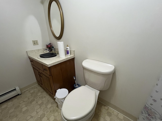 bathroom featuring vanity, toilet, and a baseboard heating unit