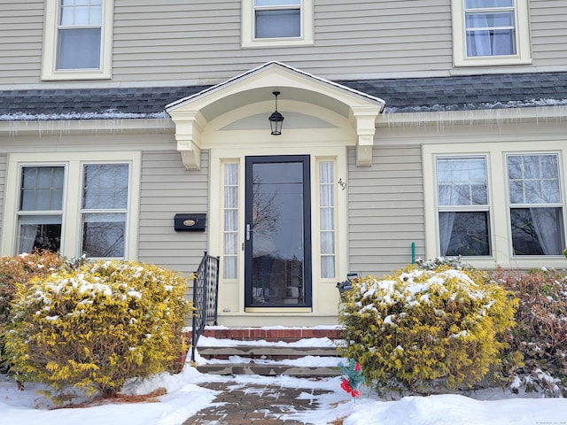 view of snow covered property entrance