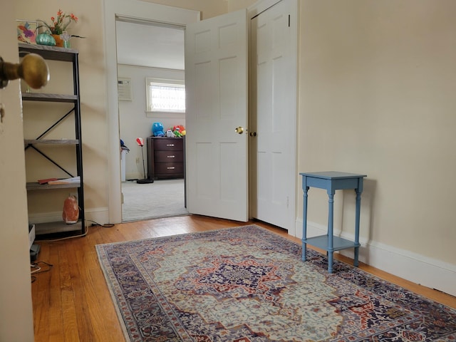 hallway with hardwood / wood-style floors