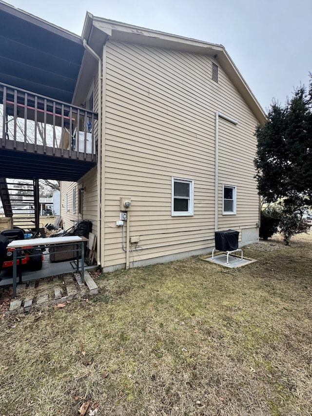 view of side of home with a lawn