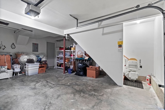 garage with a garage door opener and electric panel