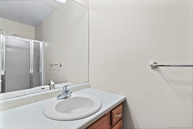 bathroom featuring vanity and an enclosed shower