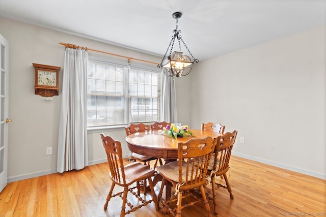 dining space featuring an inviting chandelier and light wood-type flooring