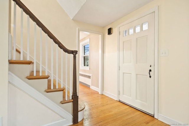 entrance foyer featuring hardwood / wood-style floors and radiator heating unit