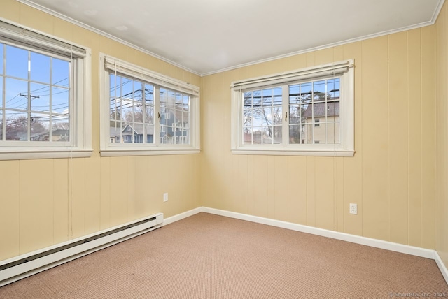 carpeted spare room featuring crown molding and a baseboard heating unit