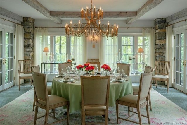 dining area featuring a chandelier, beam ceiling, and french doors