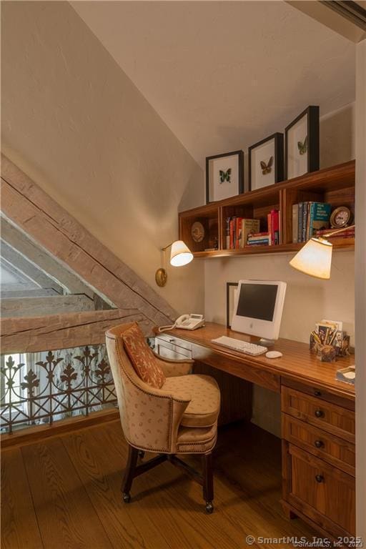 office featuring hardwood / wood-style flooring and built in desk