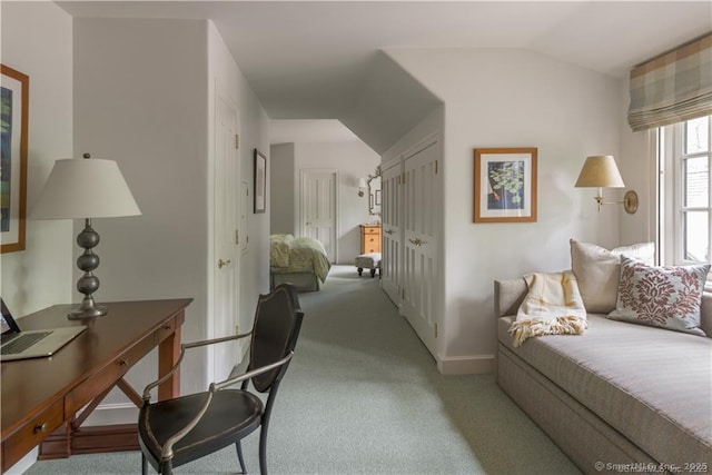 carpeted bedroom with lofted ceiling