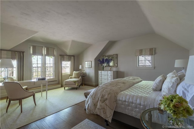 bedroom featuring vaulted ceiling and hardwood / wood-style floors