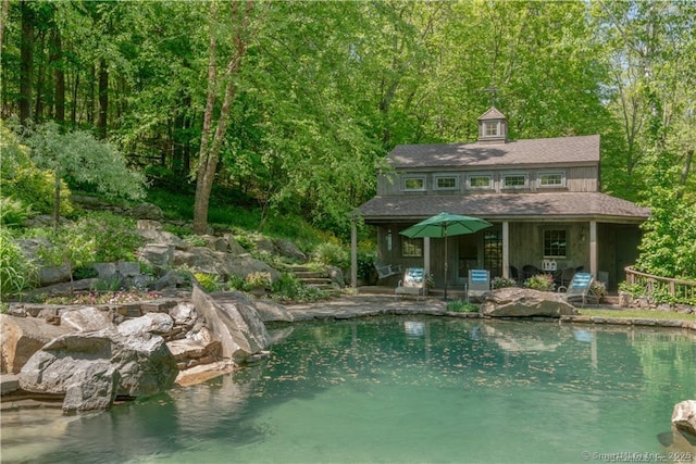 view of pool featuring a water view